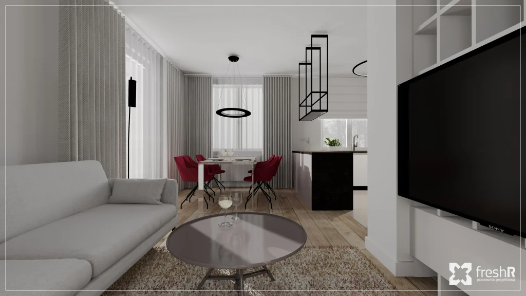 Przestronny salon z jadalnią i kuchnią w inwestycji Domy w Mnikowie – jasne wnętrze z nowoczesnym oświetleniem.